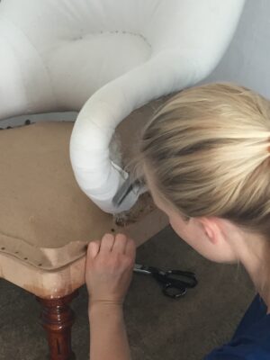 A photo from the upholstery course at Farnham School of Furniture. It shows a chair being covered.