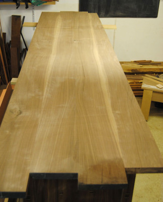 Jointed walnut top laid on the sideboard