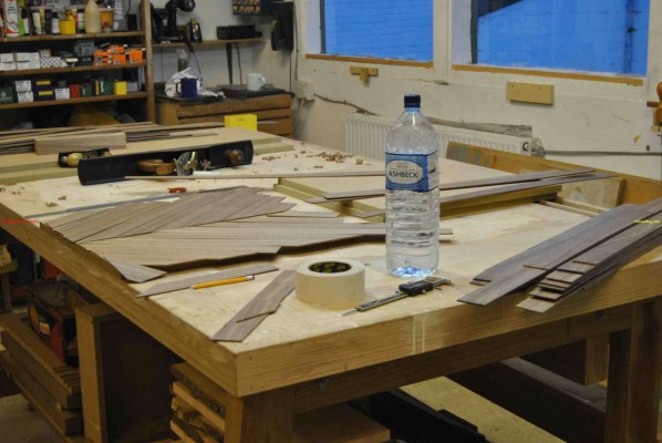 Hand jointing veneer strips on a shooting board
