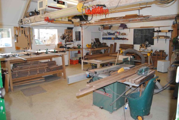 Sideboard components stacked in the workshop