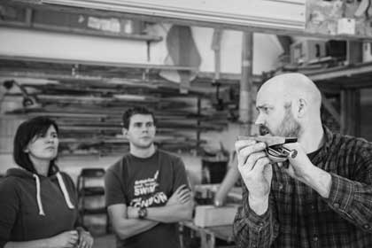 Aidan with long-term furniture making course students