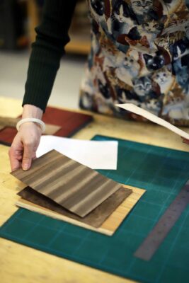 A photo from the Marquetry Course at Farnham School of Furniture Making. It shows a course pupil preparing some material for detailed marquetry.